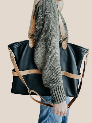 model is wearing a leather laptop tote bag, black leather handbag, lots of interior function, designer details, handmade in USA, sustainably sourced leather