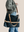 model is wearing a leather laptop tote bag, black leather handbag, lots of interior function, designer details, handmade in USA, sustainably sourced leather